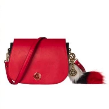 Red leather handbag with gold hardware and a black, white, and red fur charm, shown after background removal.Red leather handbag with gold hardware and a black, white, and red fur charm, shown after background removal.