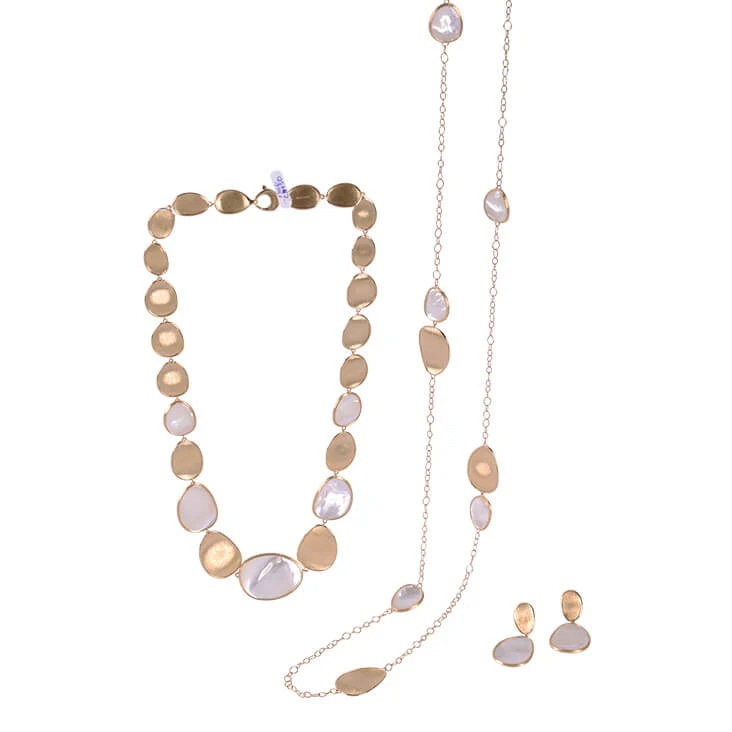 Gold and pearl jewelry set featuring a necklace, chain, and earrings, displayed after background removal.