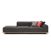 Charcoal gray modular sofa with coral and gray accent cushions, featuring a sleek minimalist design.
