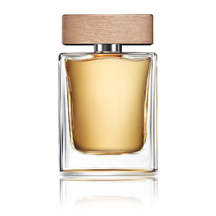 Transparent glass perfume bottle with wooden cap, enhanced by a subtle reflection shadow.