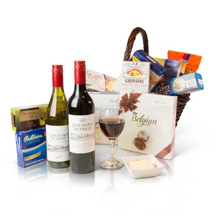 A gift basket with wine, chocolates, and snacks, enhanced with realistic shadows using Path Edits’ shadow services.