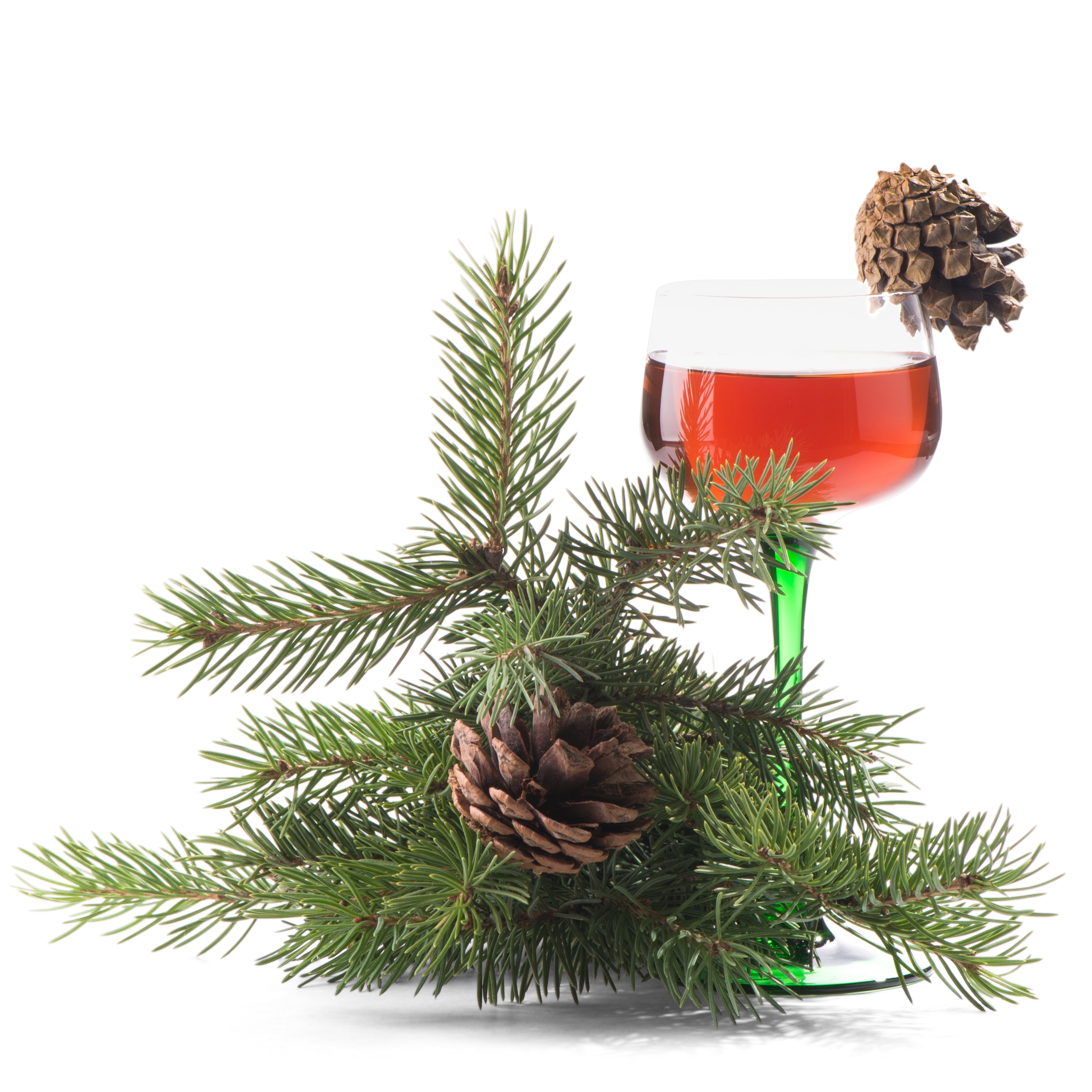 A wine glass with red liquid, pine branches, and pinecones, with natural cast shadows preserved for realism.