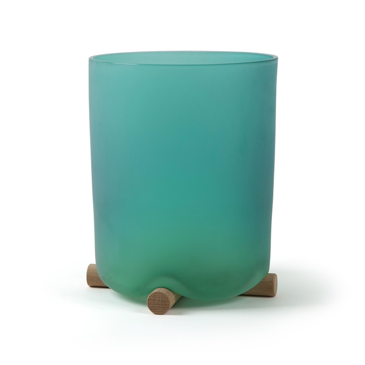 A green frosted glass vase with wooden supports, showcasing preserved natural shadows for realistic product presentation.