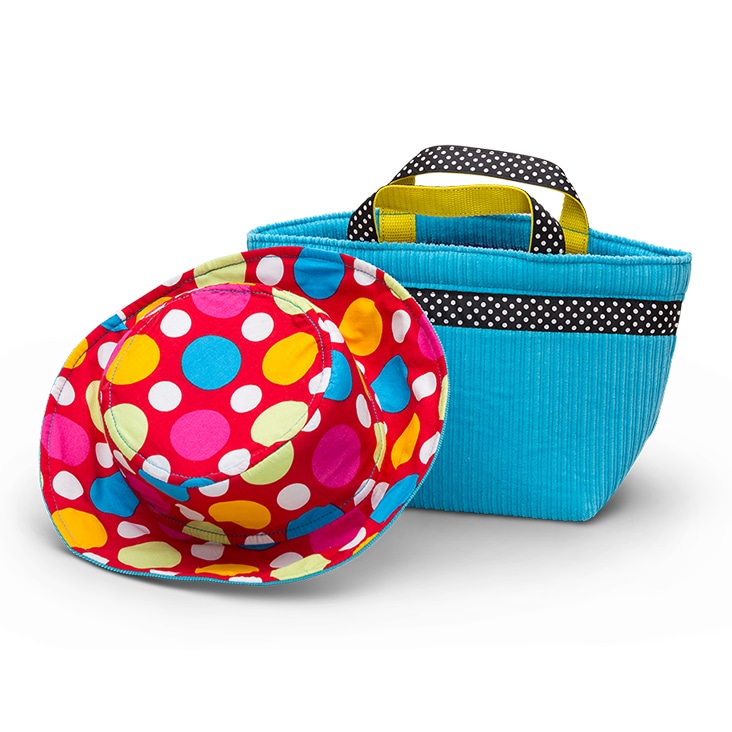A colorful polka dot hat and blue bag with realistic shadows, enhanced by Path Edits’ shadow creation services.