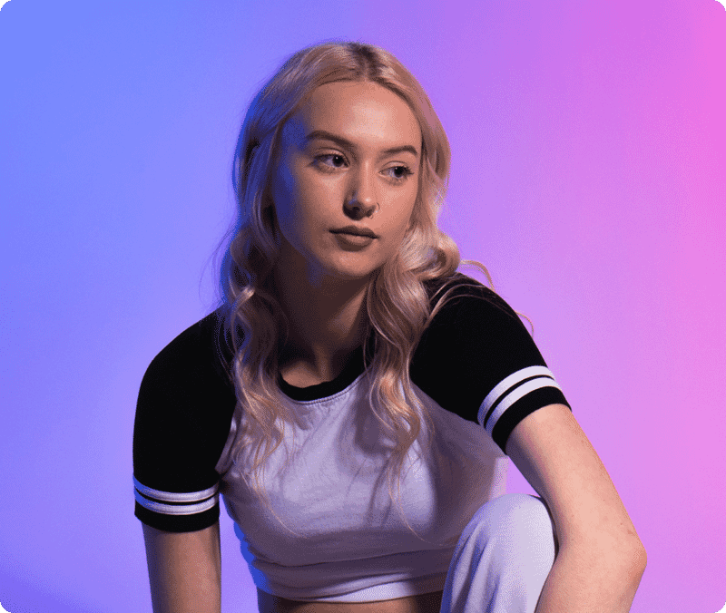 Retouched blonde woman portrait with image masking, detailed hair edges, and colorful blue-to-pink gradient background.