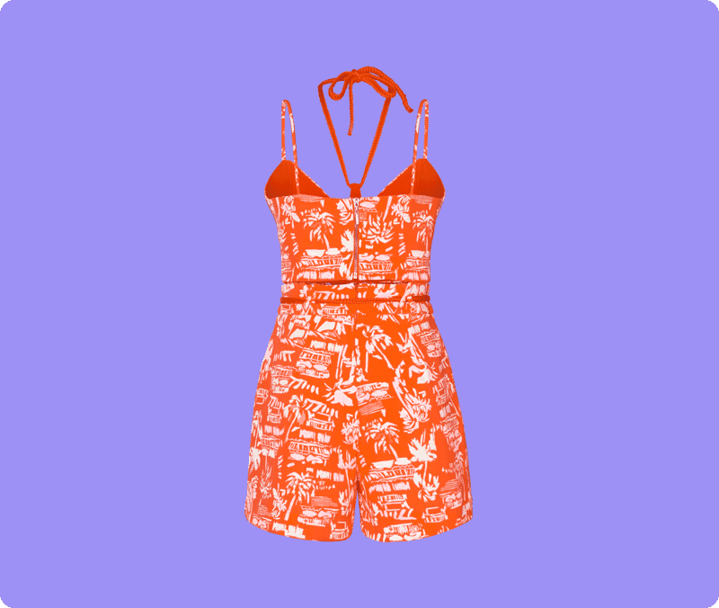 Orange tropical print romper edited with ghost mannequin effect on a purple background for clean fashion product photography.