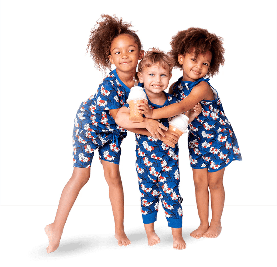 Three children in matching floral outfits holding bottles, showcasing Ice Cream Castles' product photography with Path services.