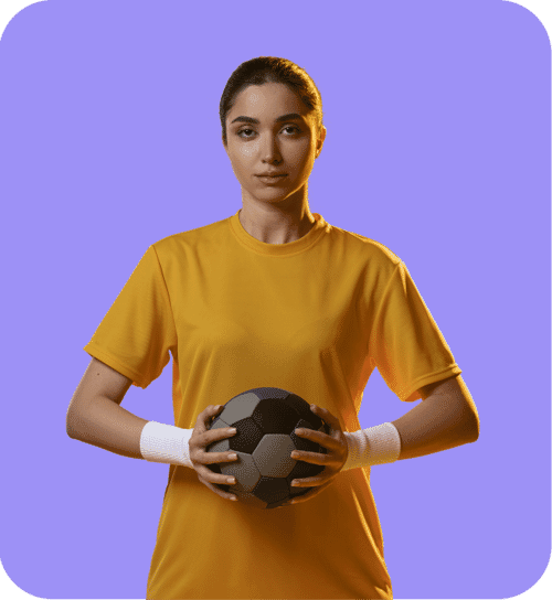 Female soccer player in a yellow shirt holding a soccer ball on a purple background with clean sports photo editing.