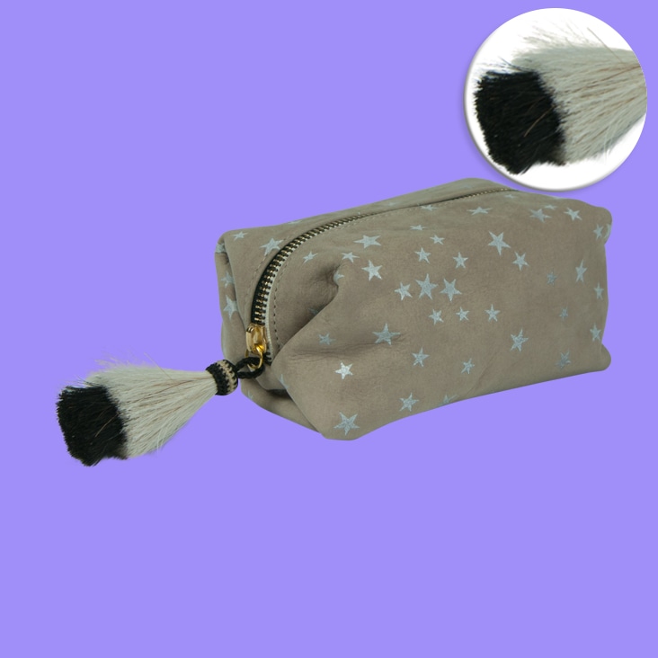 Basic Photoshop masking applied to a star-patterned pouch with a fur tassel, showcasing clean background removal and detailing.