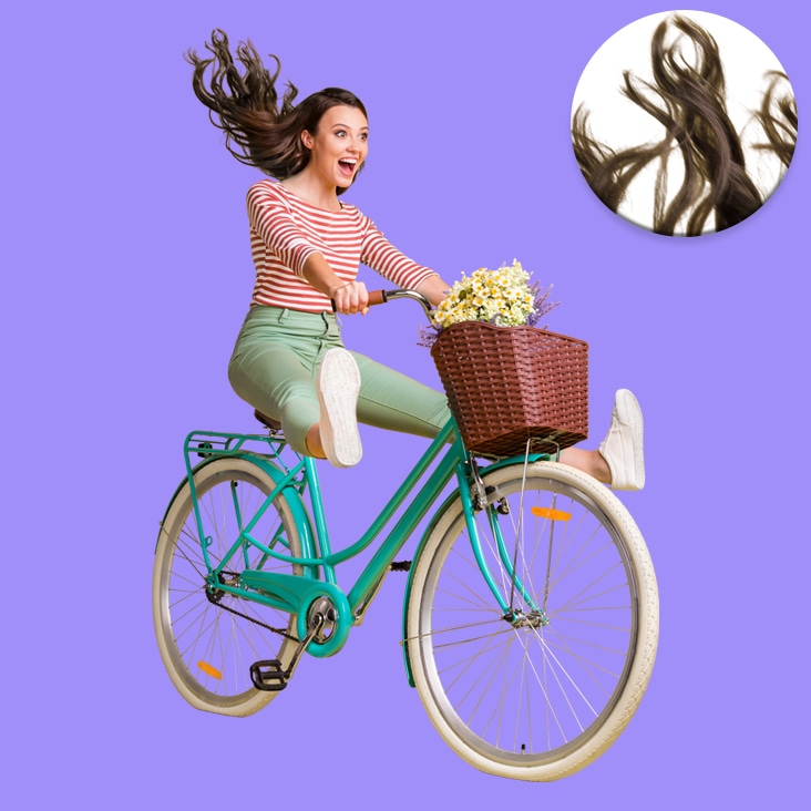 Super complex image masking applied to a woman riding a bicycle with flowing hair, highlighting intricate details and background removal.