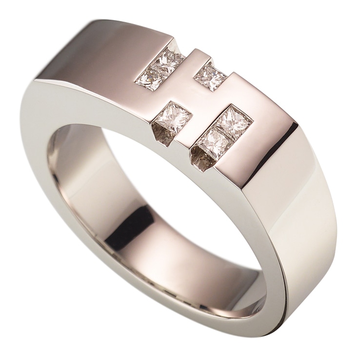 Platinum ring with square-cut diamonds, displayed with visible camera reflections before editing.