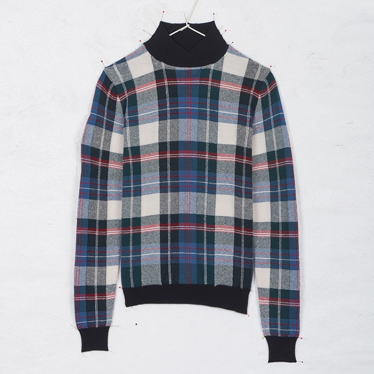 Plaid turtleneck sweater with a smooth and polished appearance, shown after wrinkle removal editing.