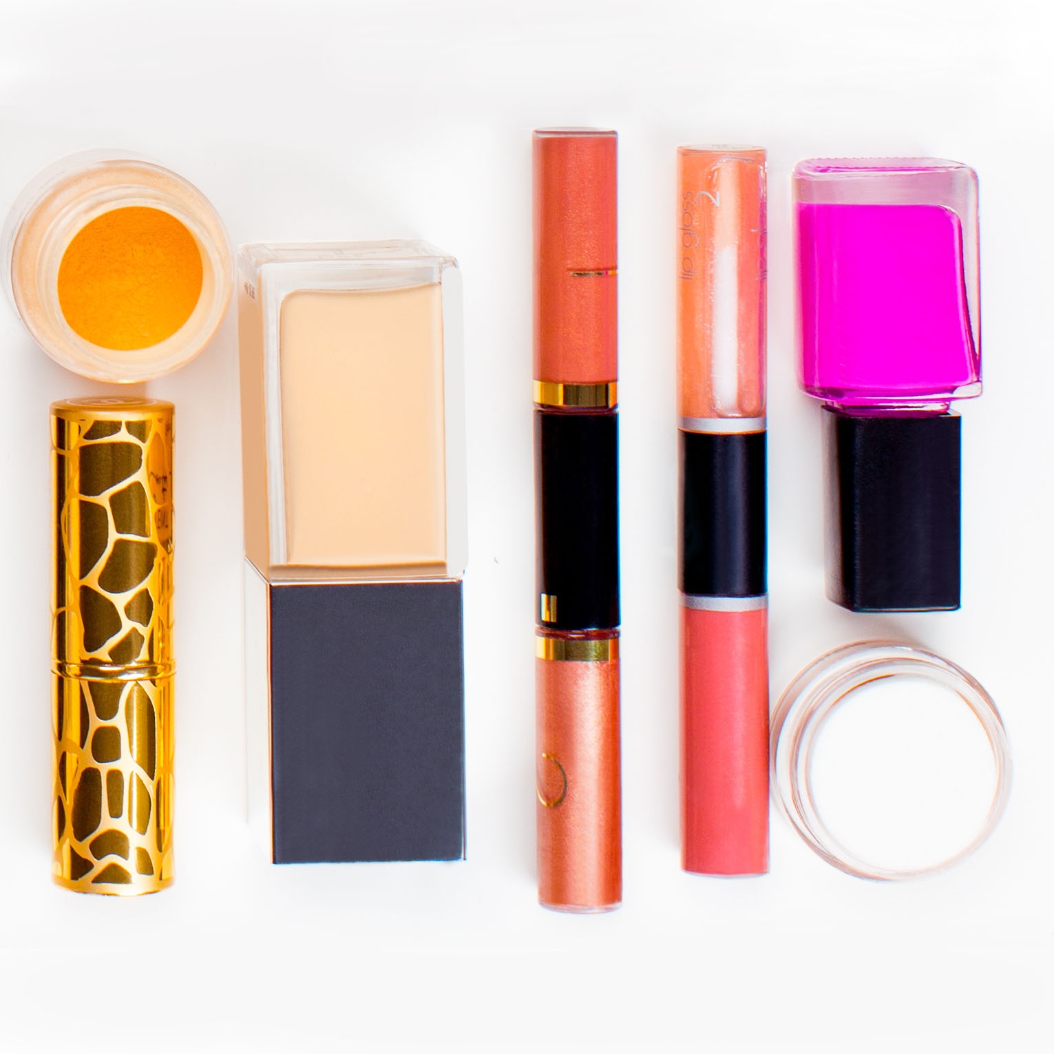 Flat lay of makeup products, including lipstick, foundation, and nail polish, with dust, spots, and scratches removed.
