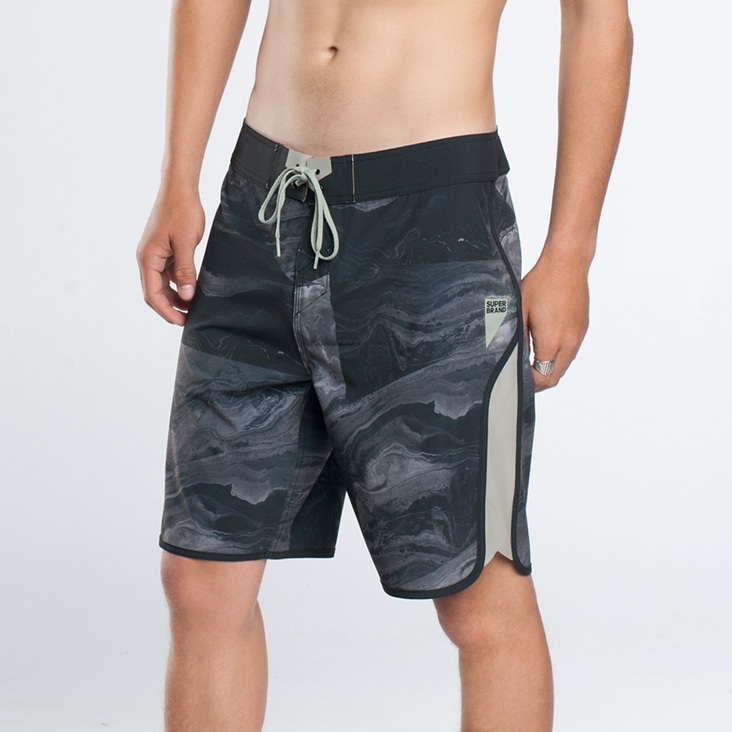 Close-up of a man modeling shorts with smooth, airbrushed skin, highlighting professional beauty retouching for apparel images.