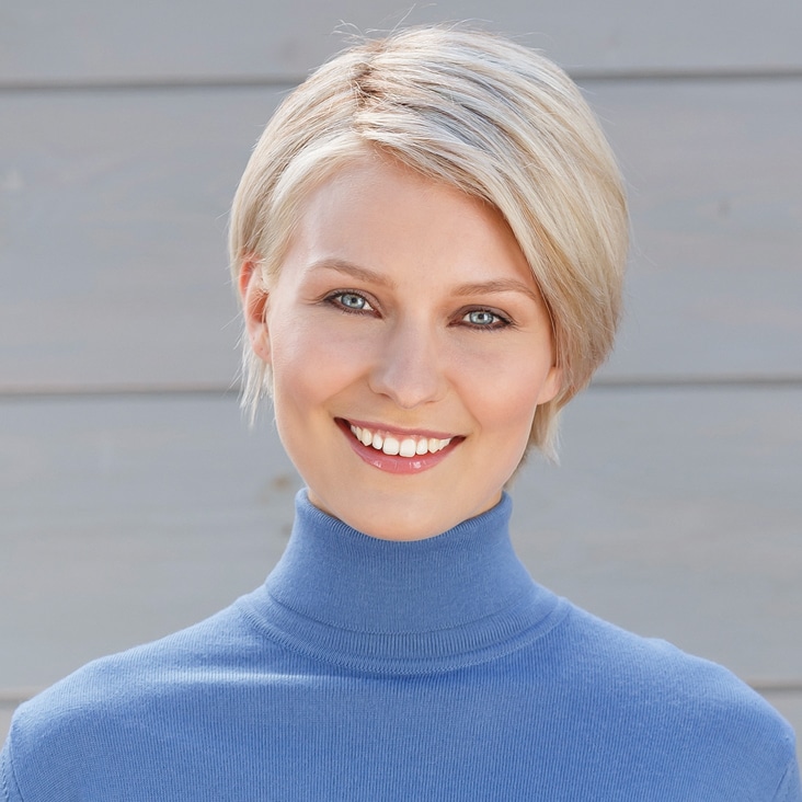 Smiling woman with smooth, airbrushed skin and flawless complexion, showcasing professional beauty retouching techniques.