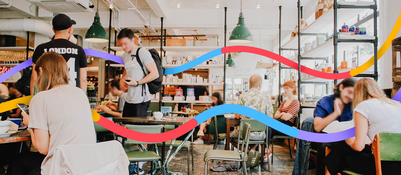 Busy café interior with patrons’ faces blurred, colorful graphic overlay for privacy and design.