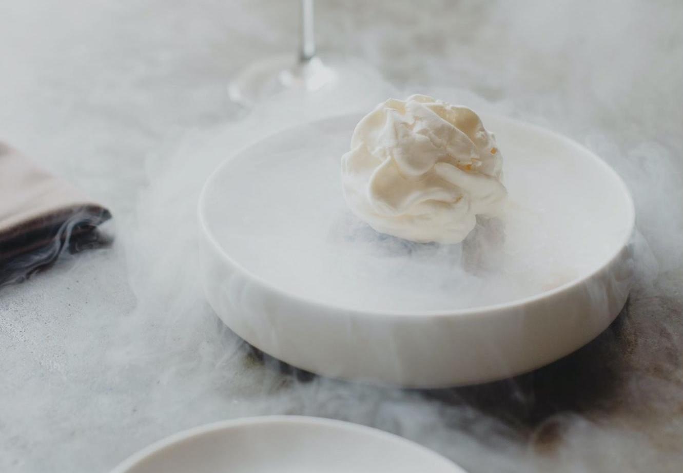 Elegant dessert served on a plate with dry ice smoke effect