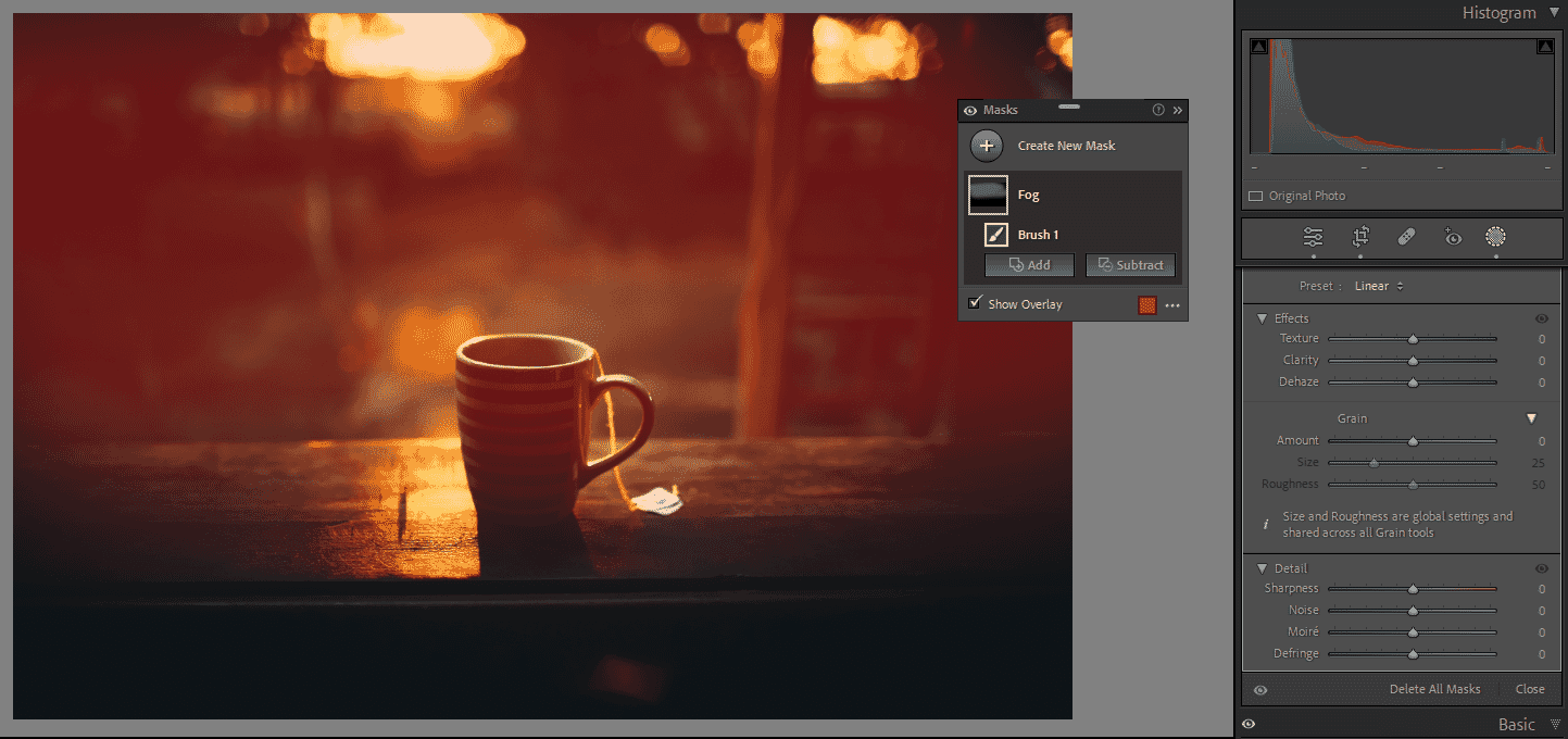 Tea cup with red overlay effect applied in Lightroom, set on a dark wooden surface