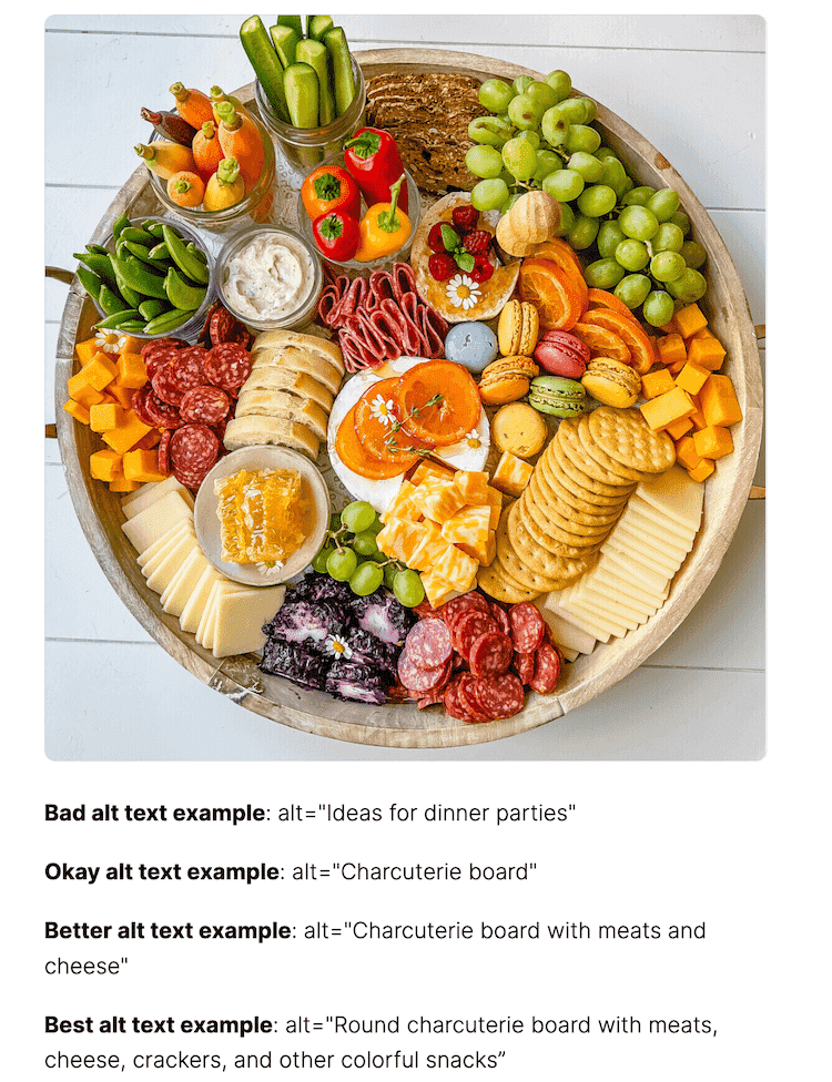 Round charcuterie board with meats, cheeses, crackers, veggies, fruits, and colorful snacks.