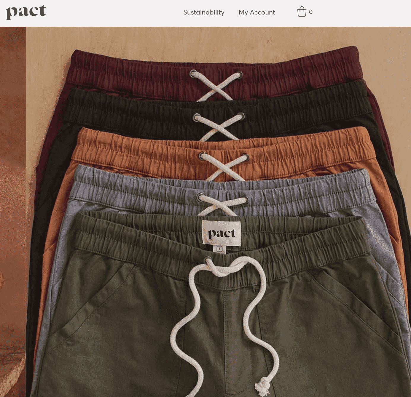 Stacked color variations of Pact lounge shorts with drawstring in olive, blue, rust, black, and burgundy