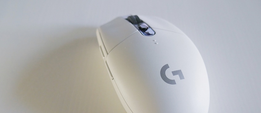 White wireless gaming mouse with a logo on a light background.