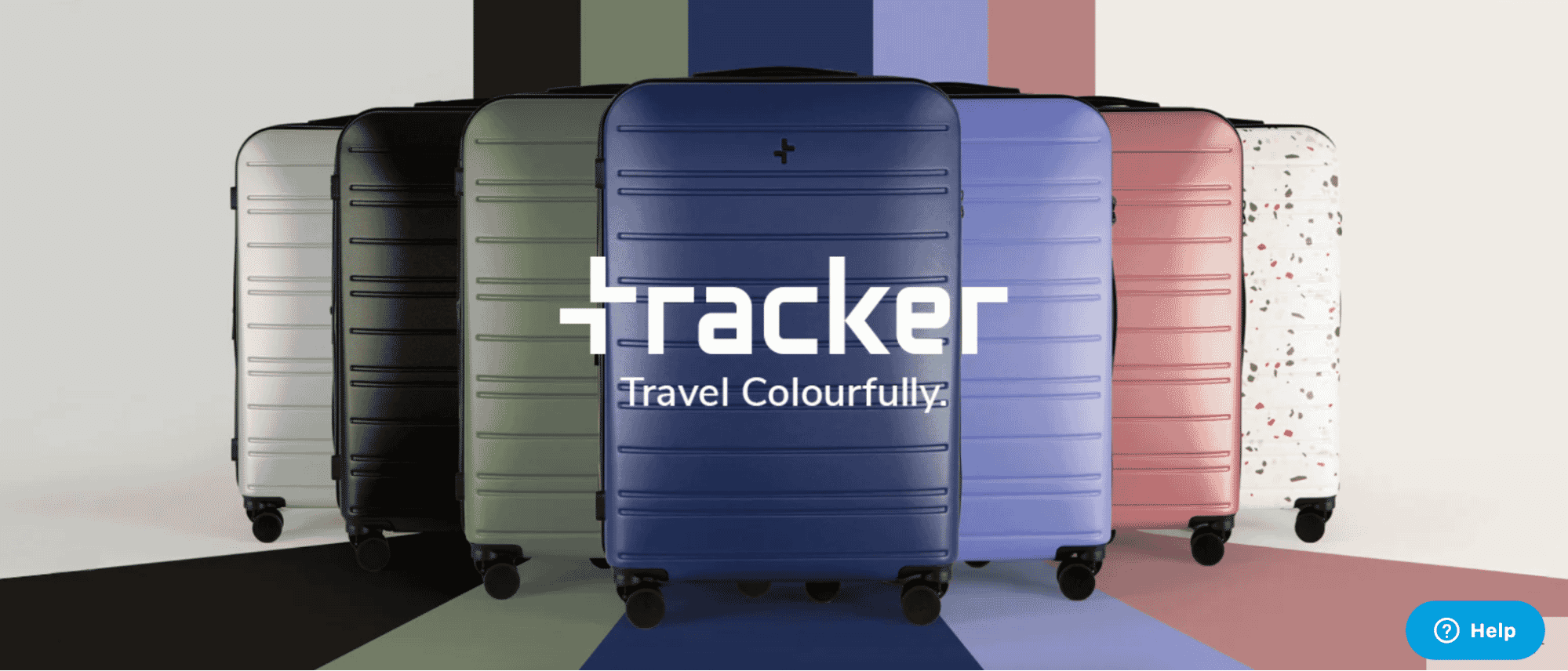 Tracker hard-shell suitcase collection in a variety of bold colors and finishes, arranged in a line with the tagline “Travel Colourfully.”