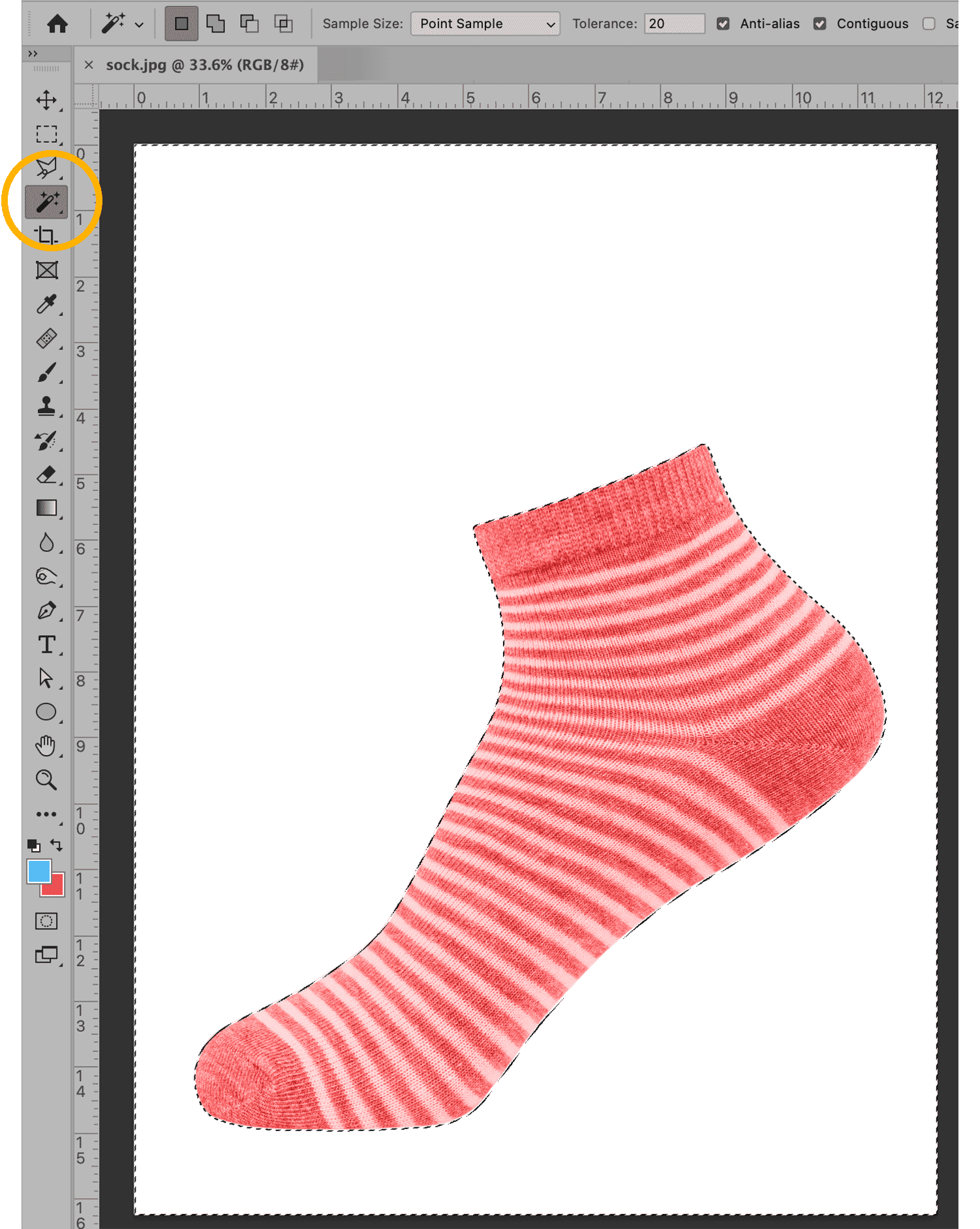 Photoshop interface showing Magic Wand tool selecting a red and white striped sock on a white background.