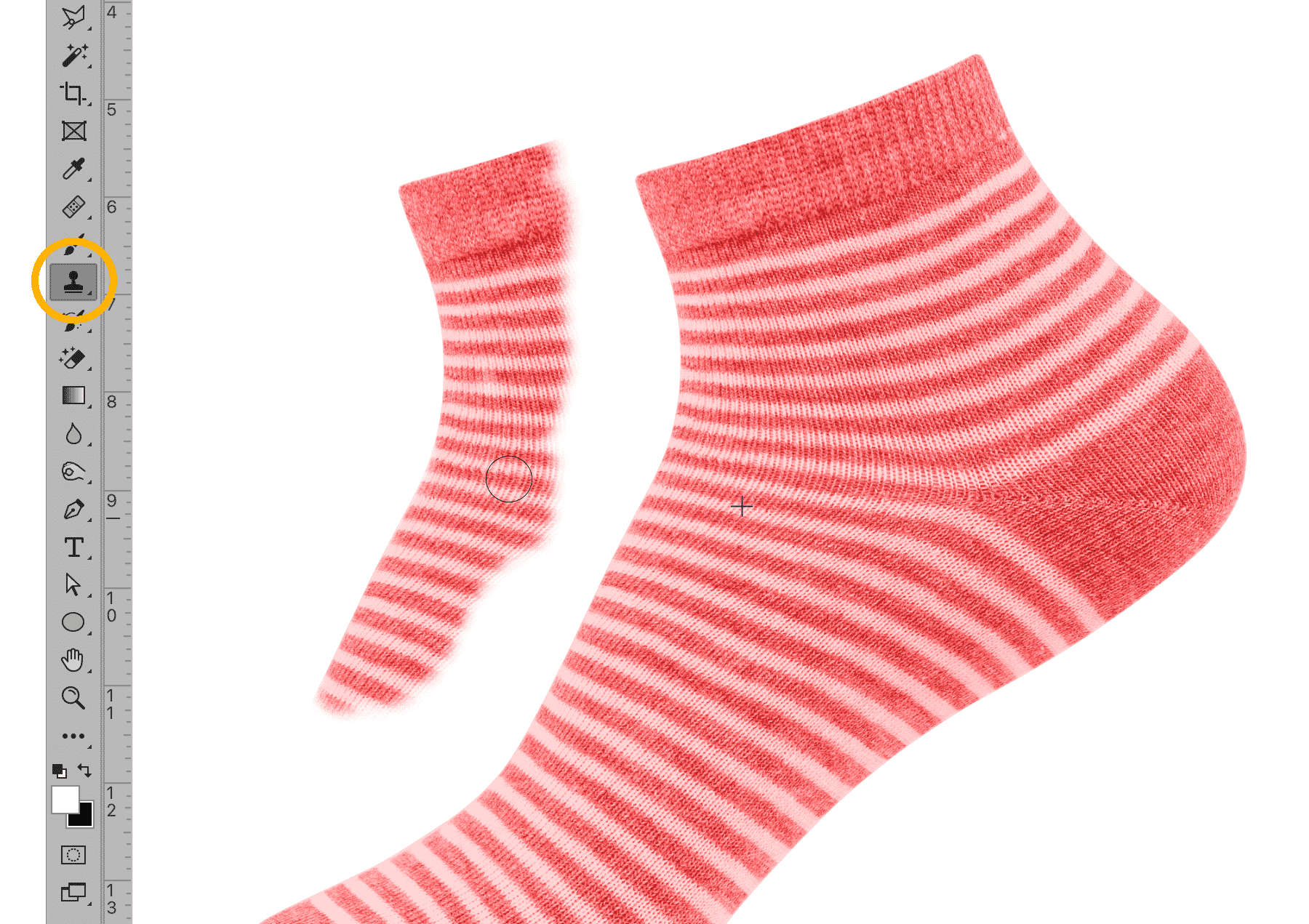 Clone Stamp tool in Photoshop duplicating part of a striped sock image, with toolbar icon highlighted.