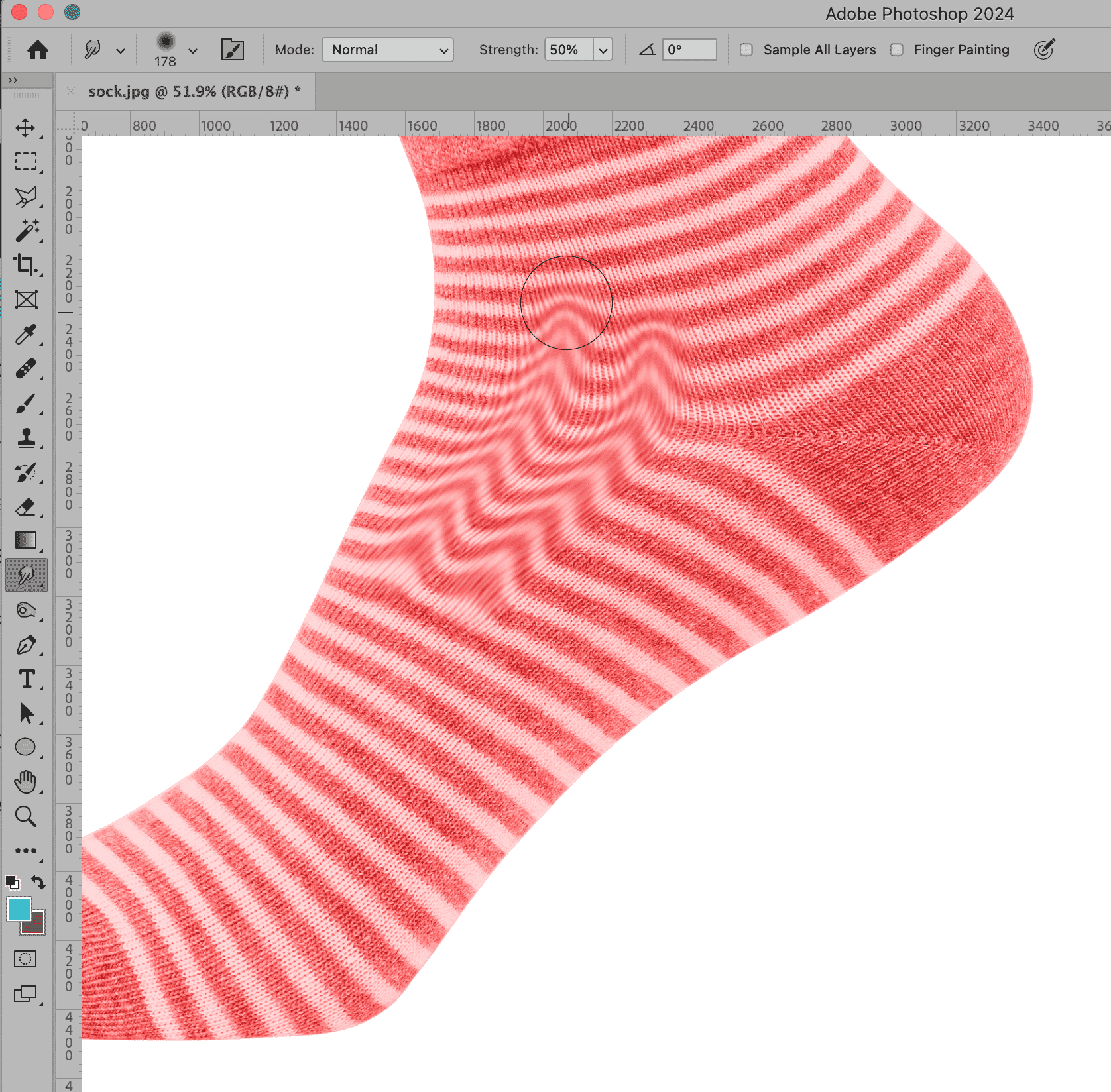Red striped sock in Photoshop with the Smudge Tool applied, creating a wavy distortion effect on the fabric.