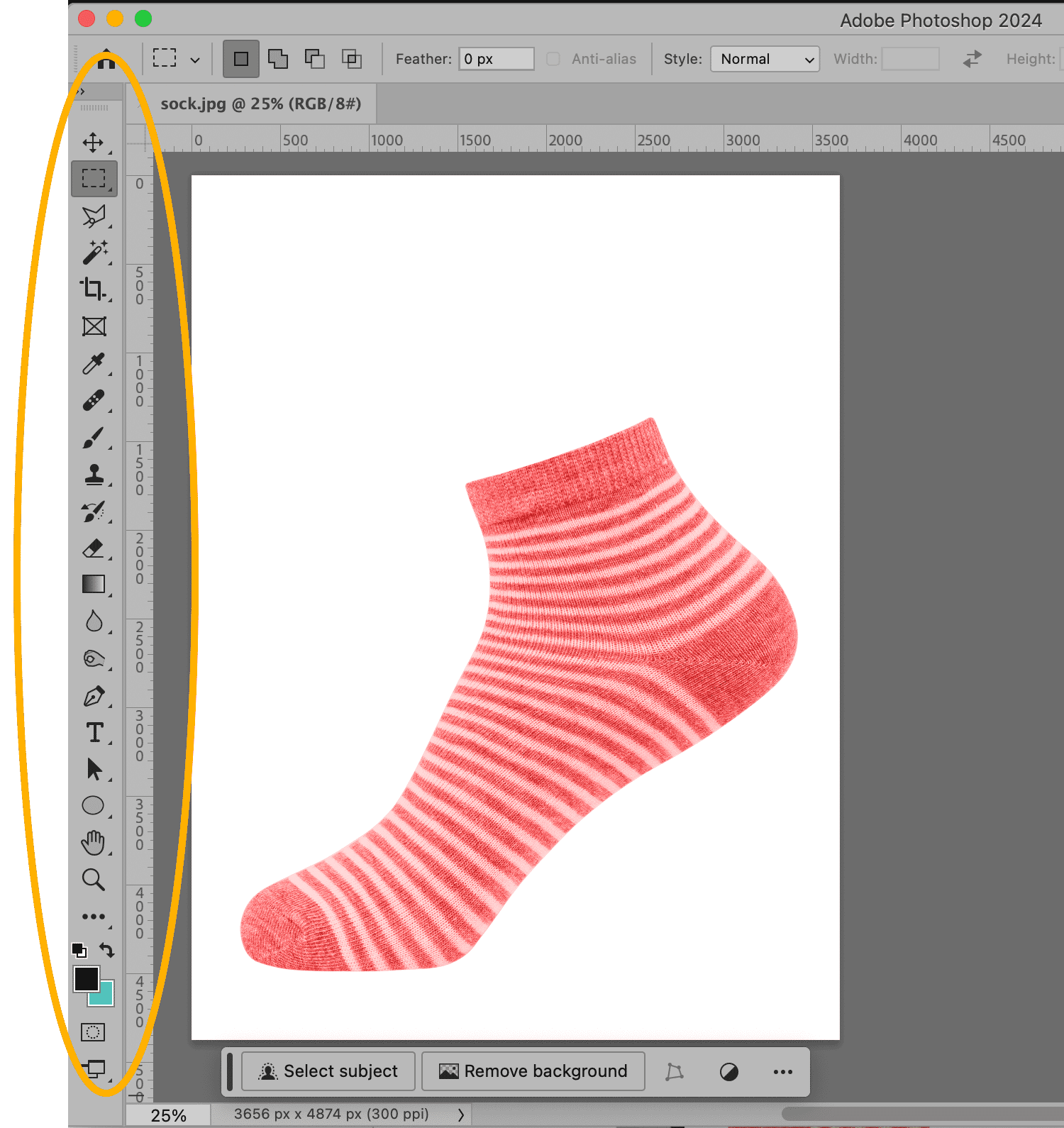 Pink striped sock displayed in Adobe Photoshop with toolbar highlighted, ready for background removal.
