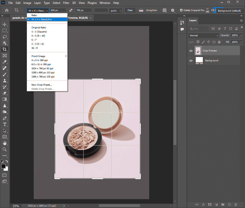 Photoshop interface showing crop tool applied to an open powder compact on a pink background.