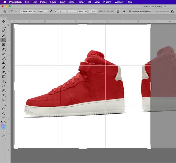 Photoshop crop tool applied to a red sneaker image with grid overlay for precise cropping and straightening