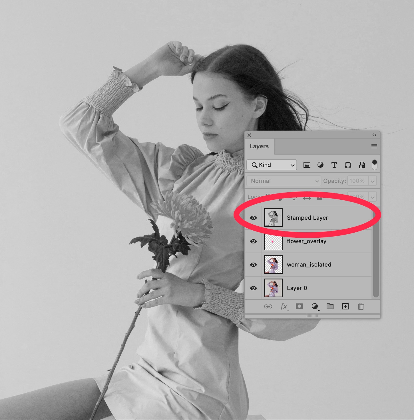 Black-and-white image of woman holding flower, with Photoshop layers panel showing a stamped layer