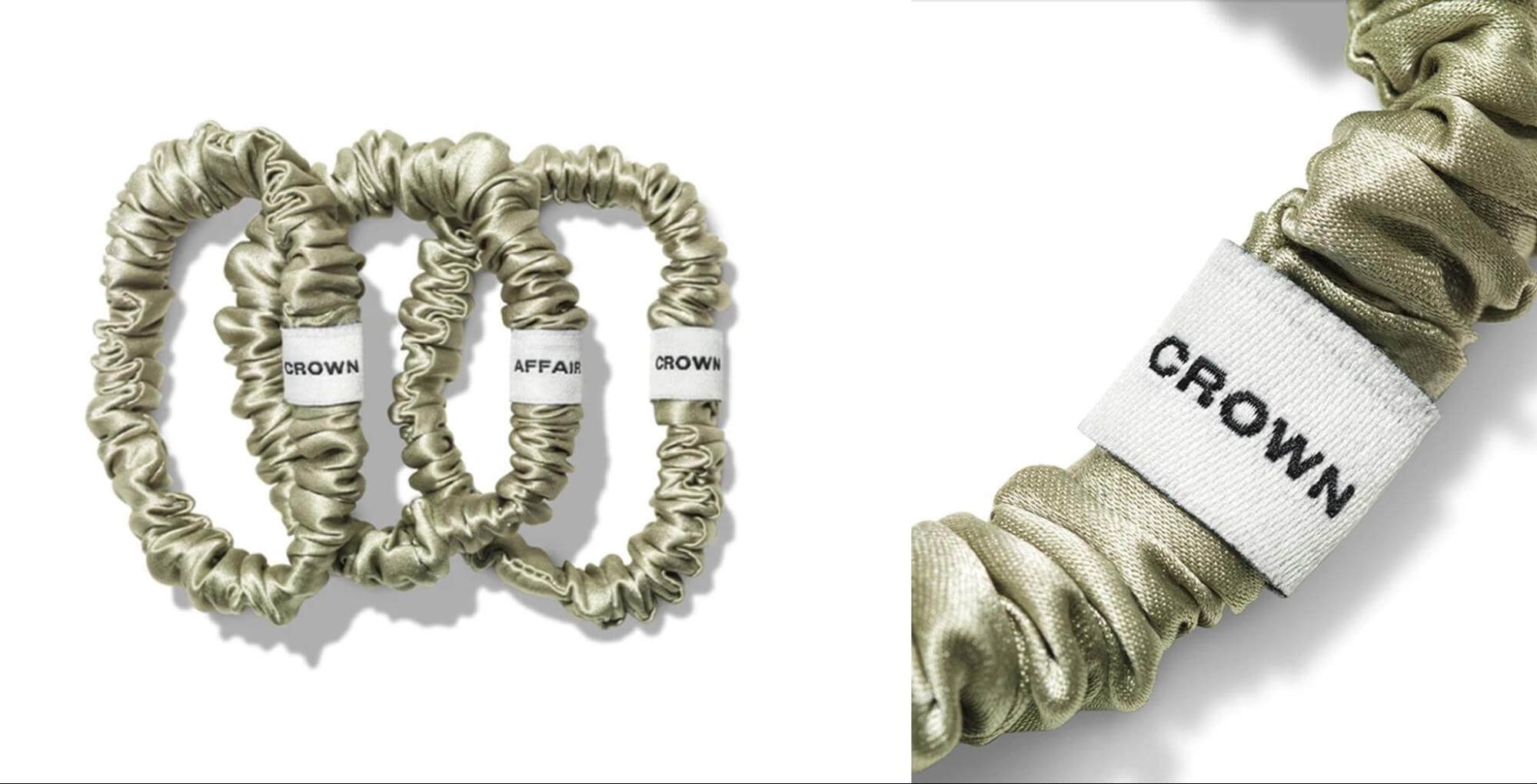 Set of three sage green silk hair scrunchies from Crown Affair with branded white labels.