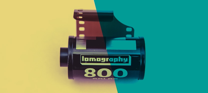 Lomography 800 film roll with yellow and teal color split effect on a solid background
