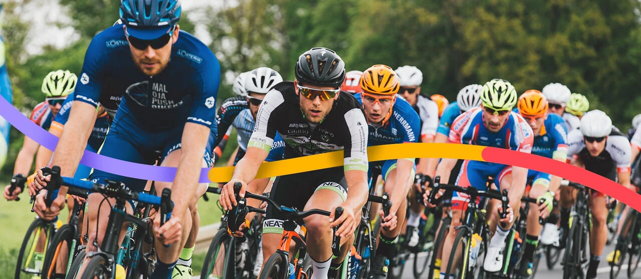 Group of cyclists in a competitive road race, focusing on motion and intensity of the event.