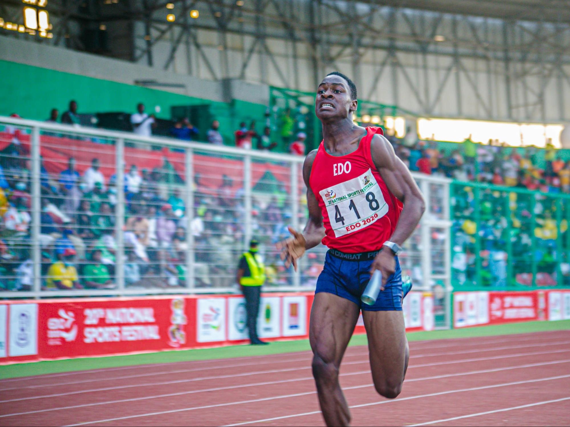 Male track athlete mid-sprint, showcasing speed and athletic form.