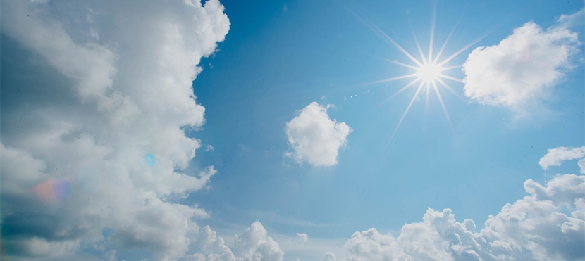 Bright, sunny sky with scattered clouds ideal for natural lighting in product photography.