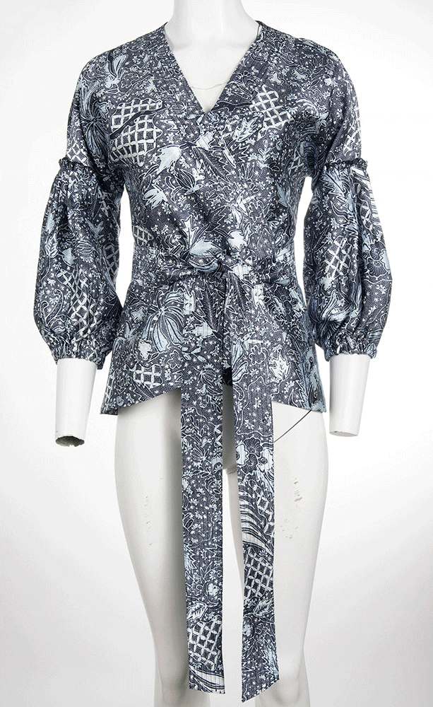 Patterned blouse displayed with ghost mannequin effect to highlight garment shape and design details.