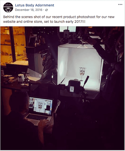 Behind-the-scenes setup of a product photoshoot for online store, featuring jewelry in a lightbox and photographer at laptop