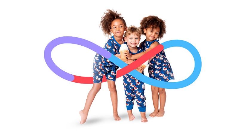 Three children in matching outfits, posing together with a colorful infinity loop design.