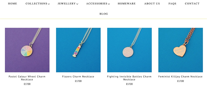 Collection of charm necklaces featuring pastel color wheel, Fizzers, inspirational, and feminist designs.