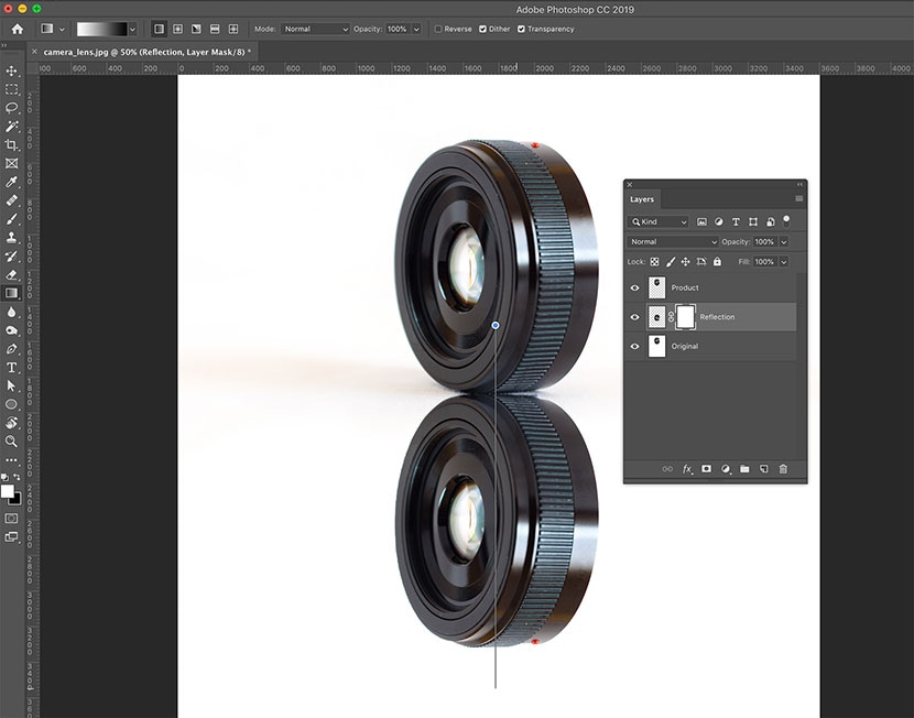 Using a gradient mask on the reflection layer of a camera lens in Photoshop to create a realistic fading effect.