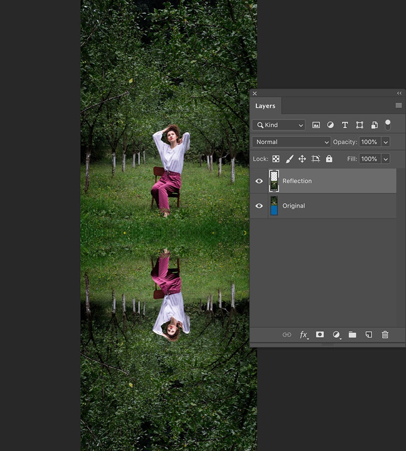 Using a flipped reflection layer in Photoshop to add a mirrored effect to an outdoor portrait of a seated model.