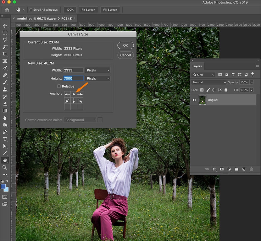Adjusting canvas size in Photoshop to add vertical space above a model in a green outdoor setting.