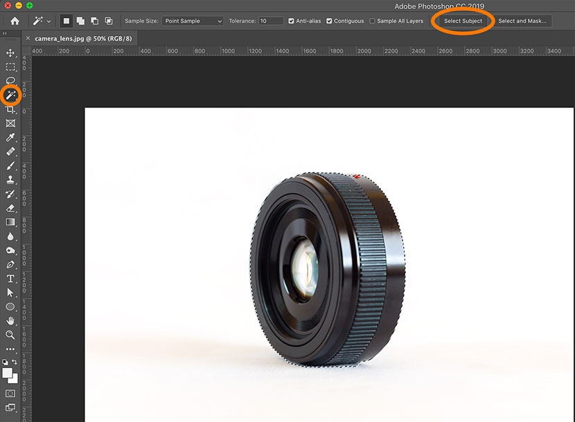 Using Photoshop's Select Subject tool to isolate a black camera lens on a white background for editing.