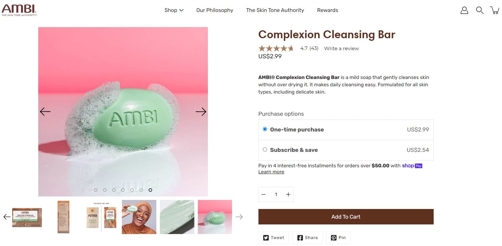 AMBI Complexion Cleansing Bar soap lathered in bubbles on a pink background, priced at $2.99.
