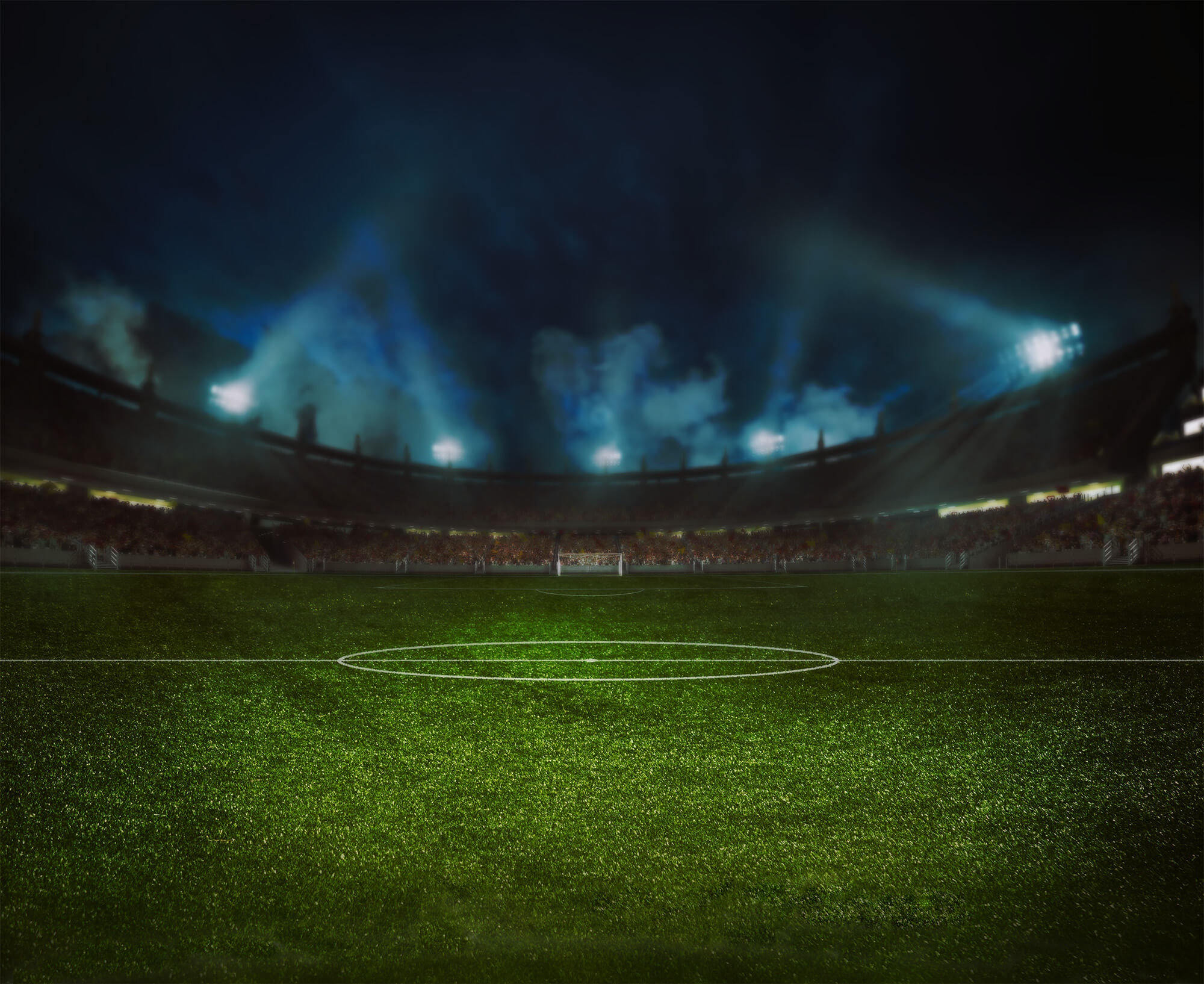photo of an empty lighted sports field at night