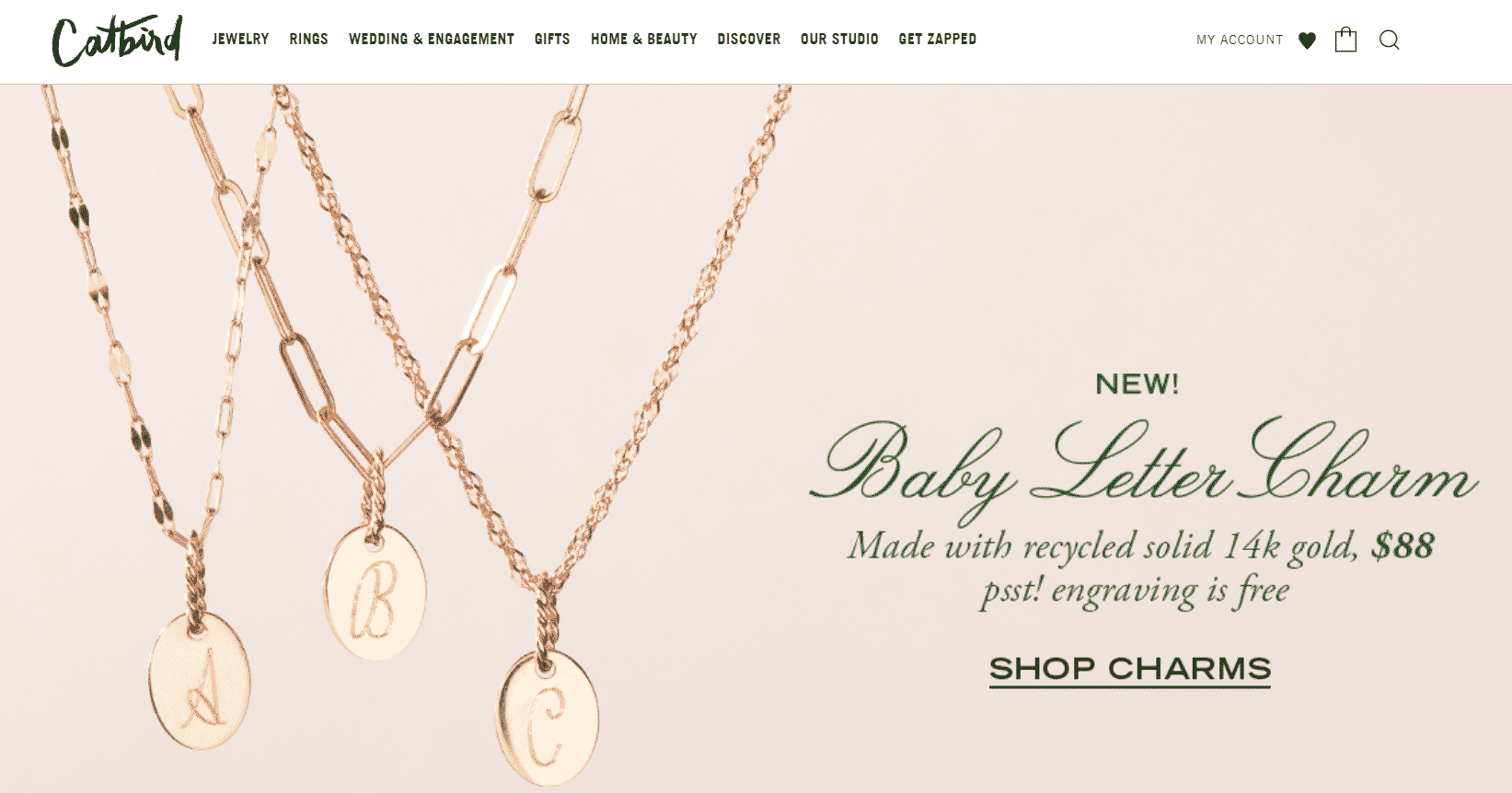 Catbird jewelry store showcasing gold letter charms with promotional text and "Shop Charms" call-to-action