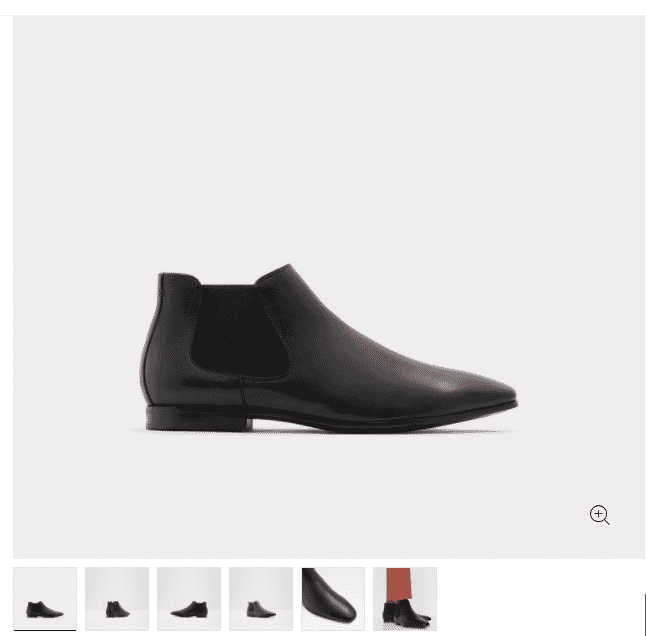 Men's black leather Chelsea boot with elastic side panel on a light grey background